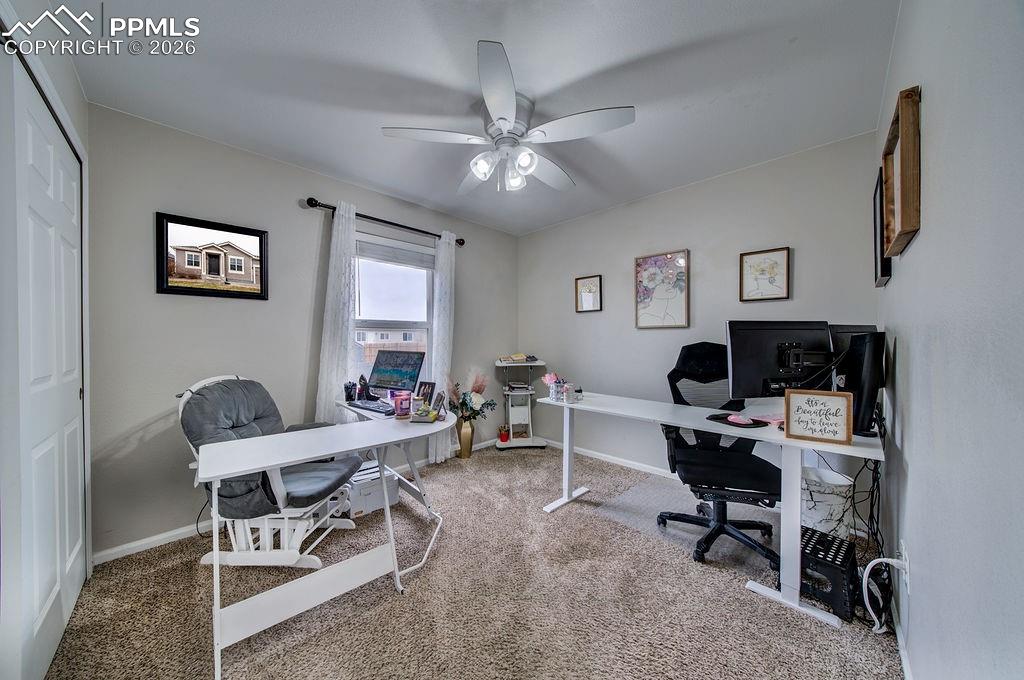 Image 33 of 48: Bedroom #2 (currently used as an office) with neutral carpet, a lighted cei