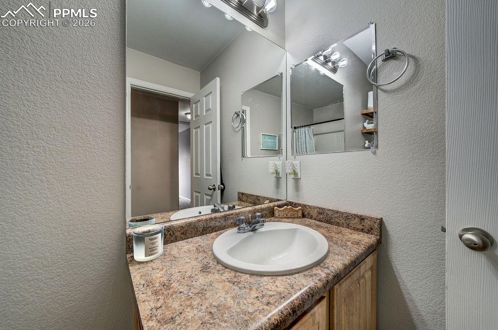 Image 39 of 48: Vanity and mirror in Full Hall Bathroom.