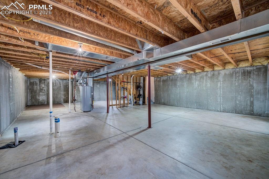 Image 41 of 48: Unfinished basement with bath rough in.