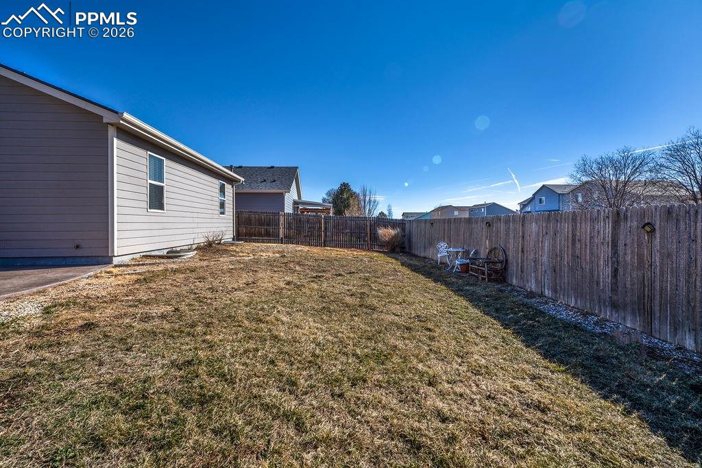 Image 47 of 48: Side fenced yard.
