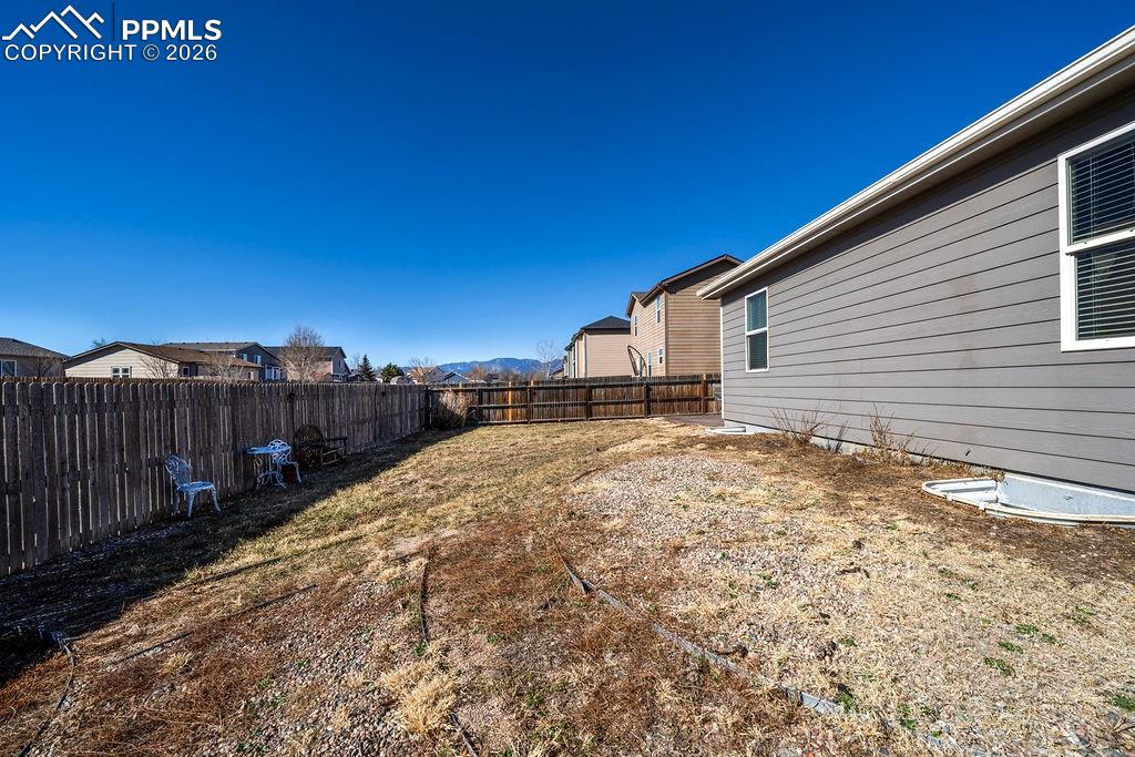 Image 48 of 48: Side fenced yard.