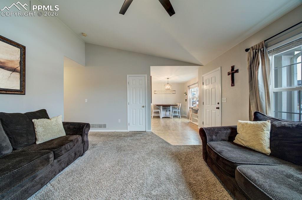 Image 7 of 48: The Living Room flows seamlessly into the Dining Area and Kitchen.