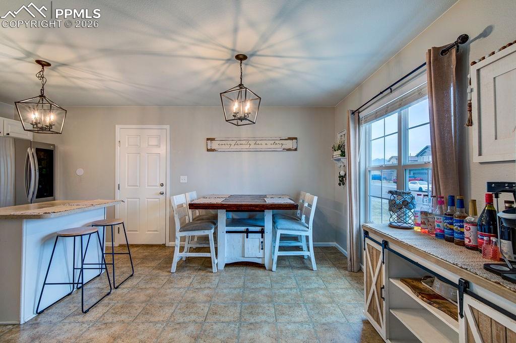 Image 9 of 48: Light and bright Kitchen/Dining Area with vinyl flooring, a large view wind