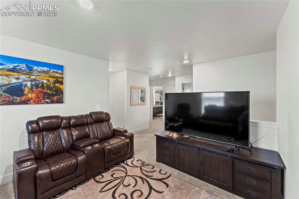 Image 19 of 39: Living room featuring light carpet and baseboards