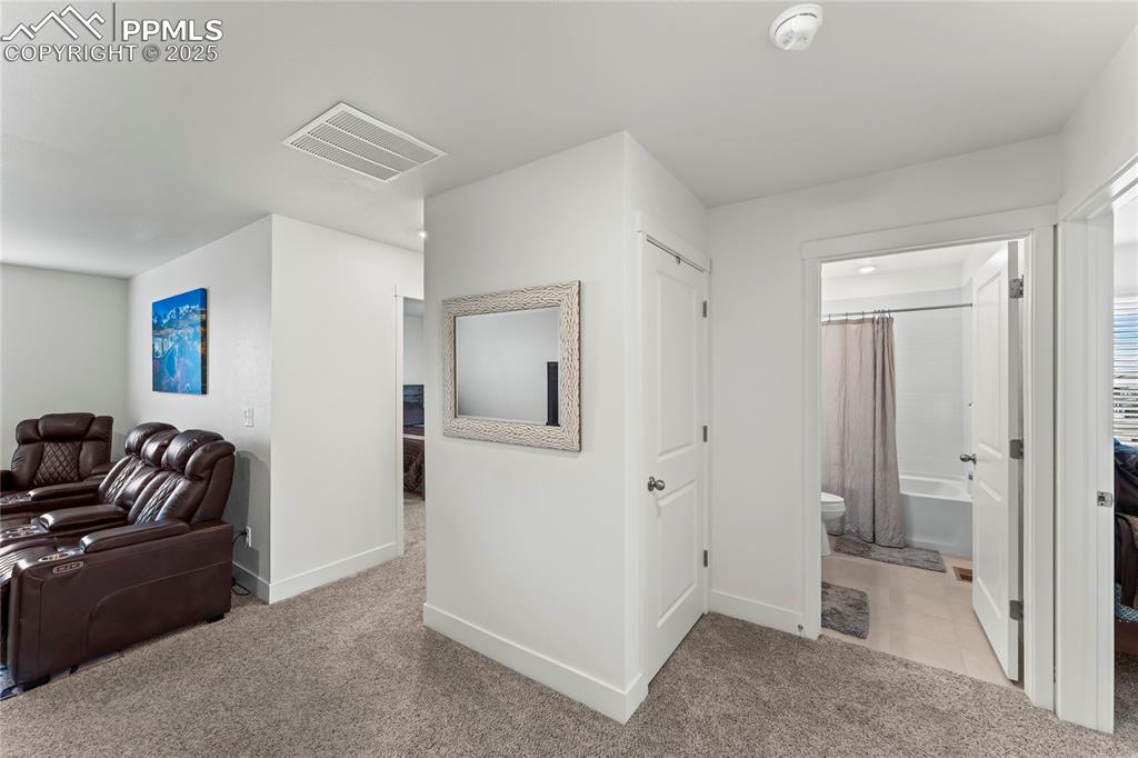 Image 21 of 39: Corridor featuring light colored carpet and light tile patterned floors