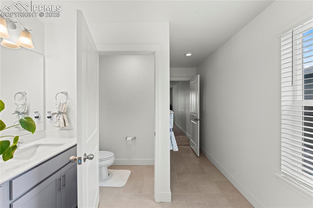Image 31 of 39: Bathroom featuring vanity and light tile patterned floors