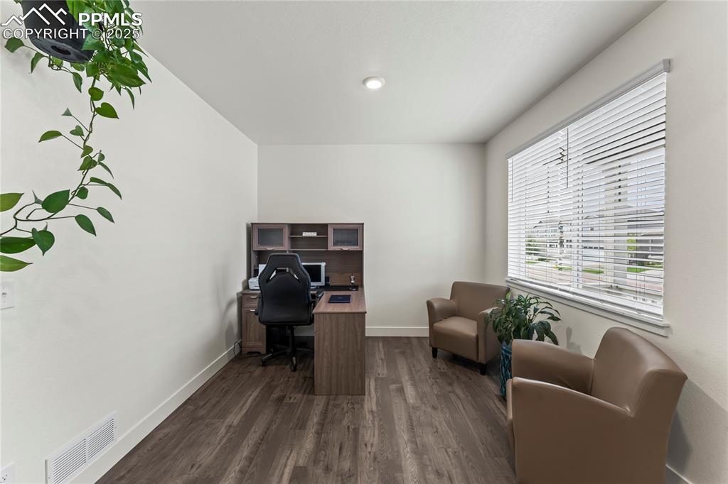 Image 6 of 39: Office with dark wood-style flooring and baseboards