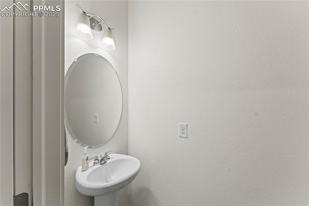 Image 8 of 39: Bathroom with a textured wall and a sink