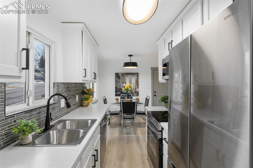 Image 16 of 36: Sleek stainless appliances and designer finishes.