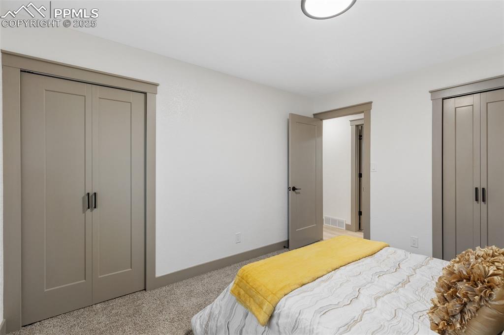 Image 18 of 36: Spacious primary suite with dual closets.