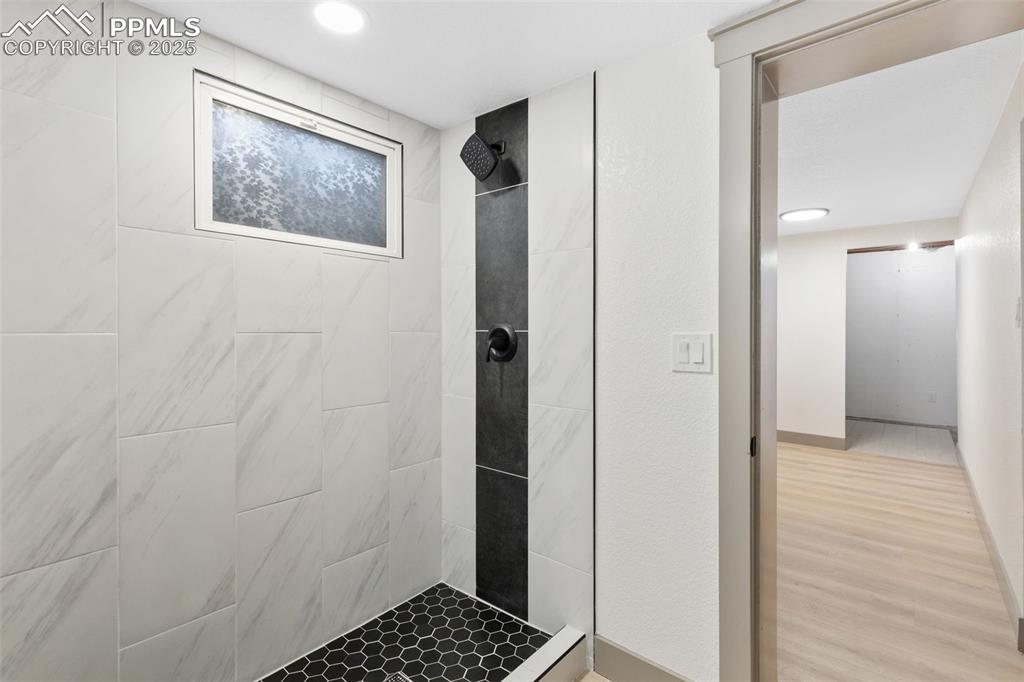 Image 25 of 36: Updated bath with walk-in shower.