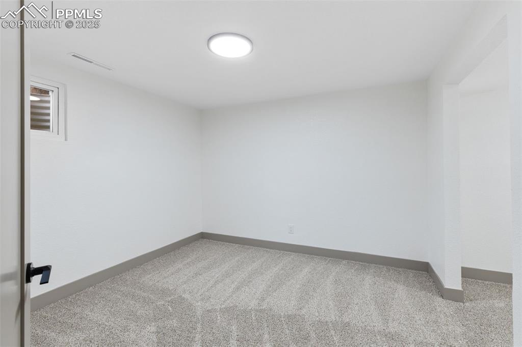 Image 28 of 36: Spacious basement bedroom with private retreat.