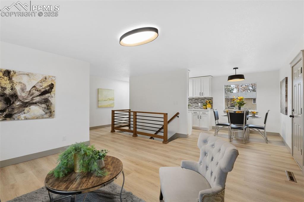 Image 8 of 36: Open layout leading to dining.