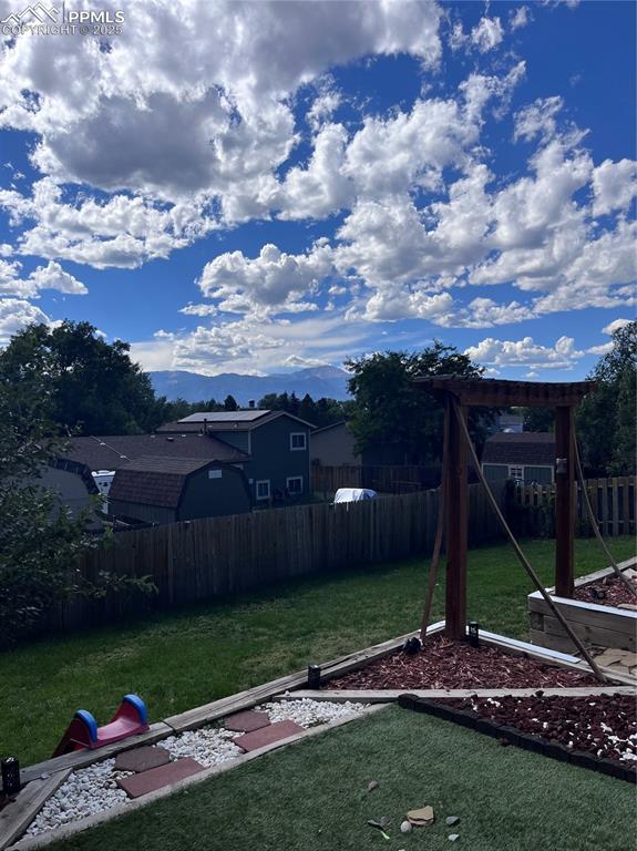 Image 35 of 38: Fenced backyard featuring a mountain view