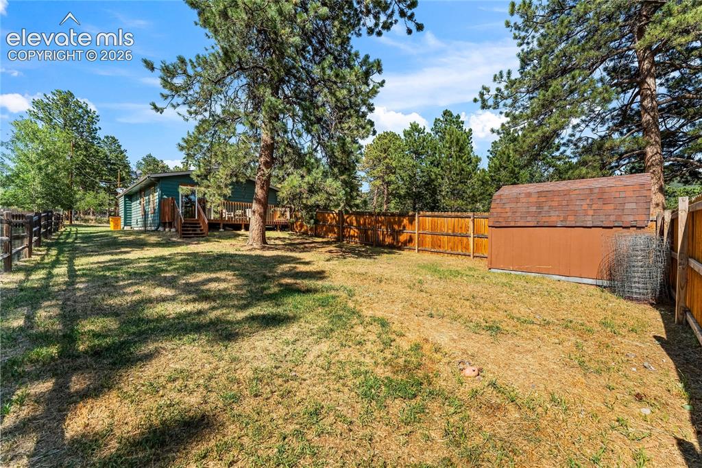 Image 14 of 32: Expansive outdoor space featuring a detached storage shed, a wood privacy f