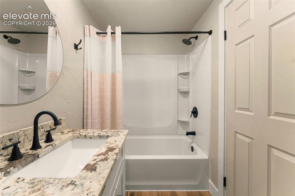 Image 31 of 32: Full bathroom featuring a single vanity with a patterned countertop, underm