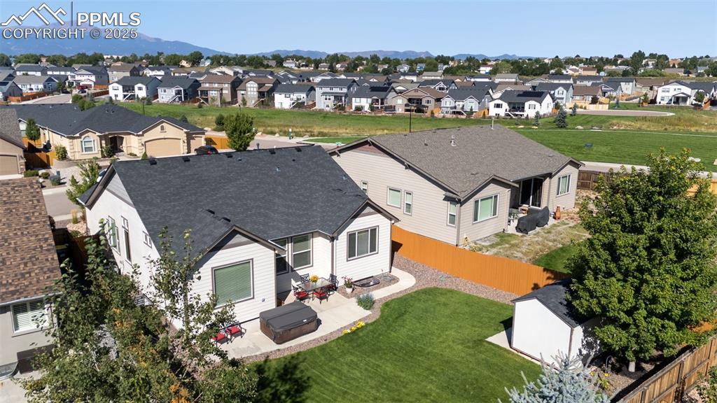 Image 4 of 43: Rear Exterior with hot tub, shed and lovely lawn