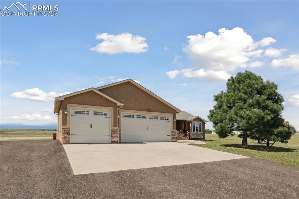 Image 2 of 42: Lovely stucco ranch with 3-car garage on 5 acres