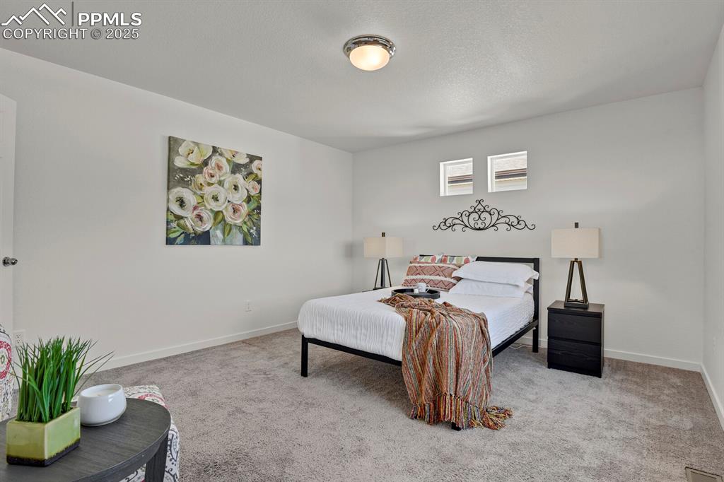 Image 13 of 24: Carpeted bedroom featuring baseboards