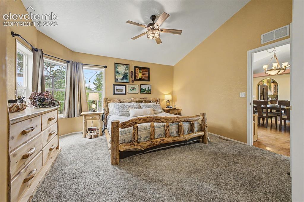 Image 14 of 48: Vaulted ceiling with an attached ceiling fan, bay window with multiple pane
