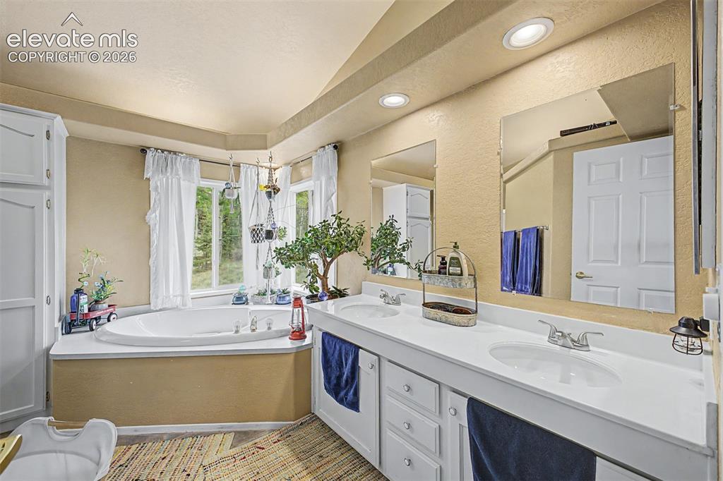 Image 17 of 48: Dual vanity with integrated sinks, framed mirrors, and recessed lighting