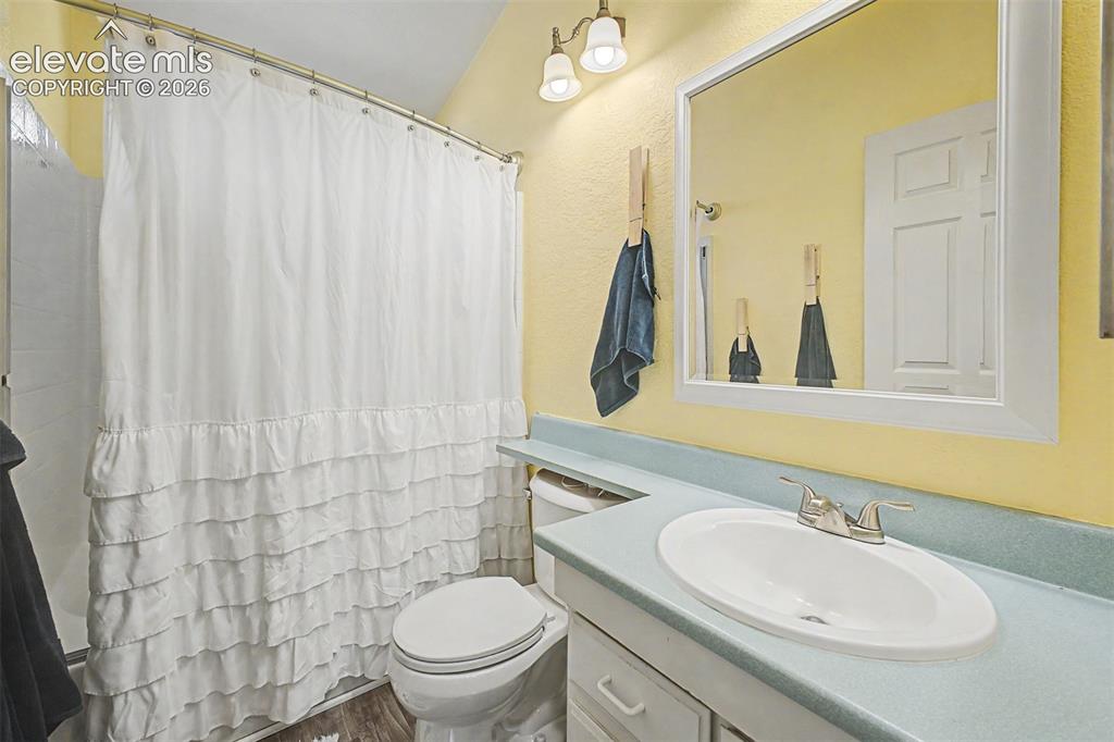 Image 31 of 48: White vanity with an integrated sink and chrome faucet