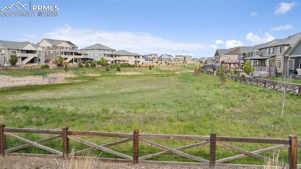 Image 10 of 46: View of yard featuring a residential view and fence