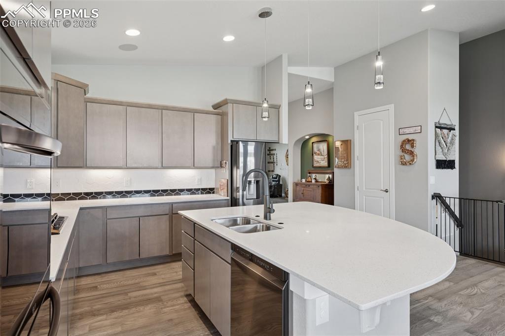 Image 17 of 46: Kitchen featuring a sink, appliances with black stainless finishes, light w