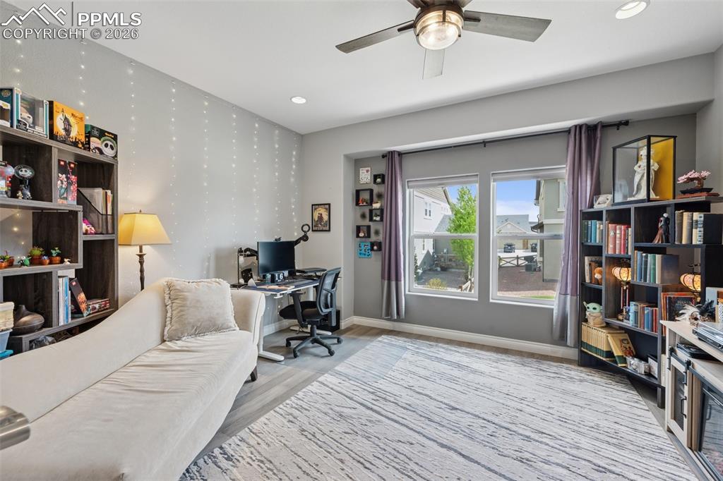 Image 28 of 46: Bedroom featuring a ceiling fan, baseboards, wood finished floors, and rece