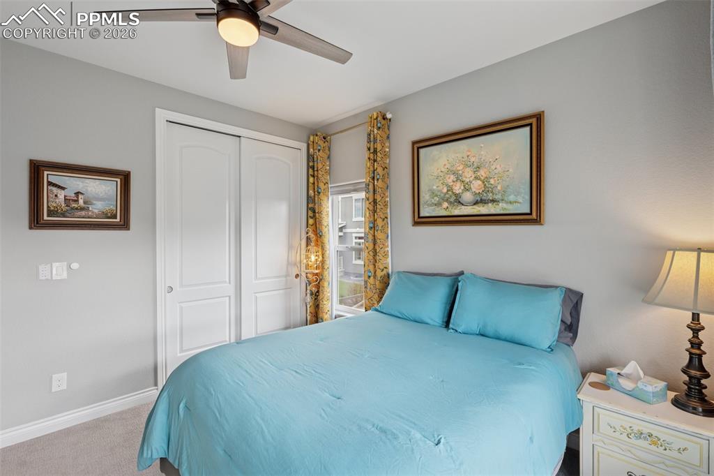 Image 31 of 46: Bedroom with a closet, carpet, baseboards, and a ceiling fan