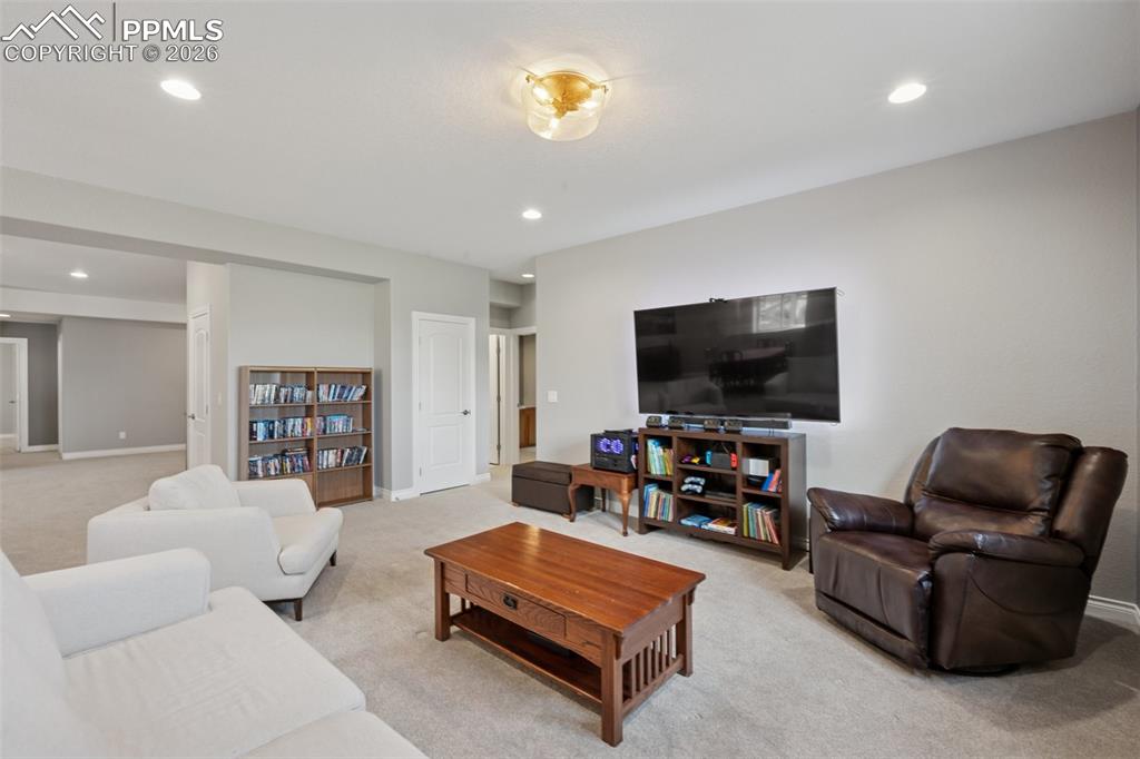 Image 35 of 46: Living room featuring light colored carpet, recessed lighting, and baseboar