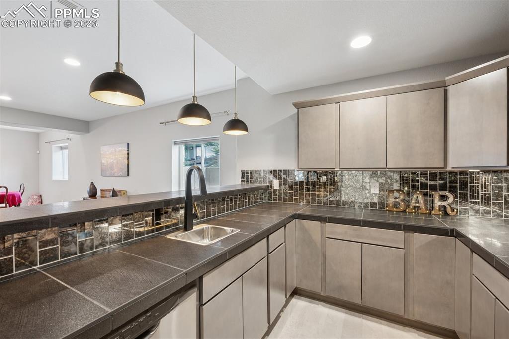 Image 38 of 46: Kitchen with a sink, plenty of natural light, decorative backsplash, recess