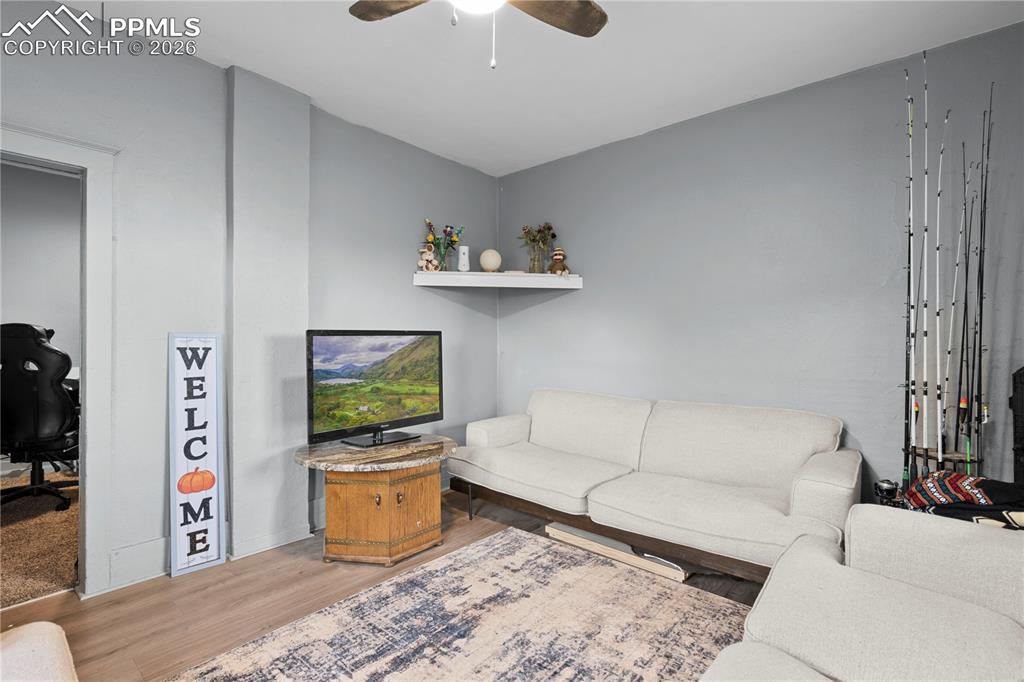 Image 14 of 18: Living area featuring wood finished floors, a ceiling fan, and an office ar