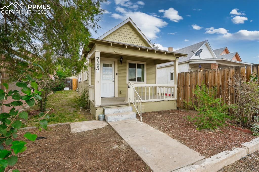 Image 2 of 18: Shotgun-style home with covered porch