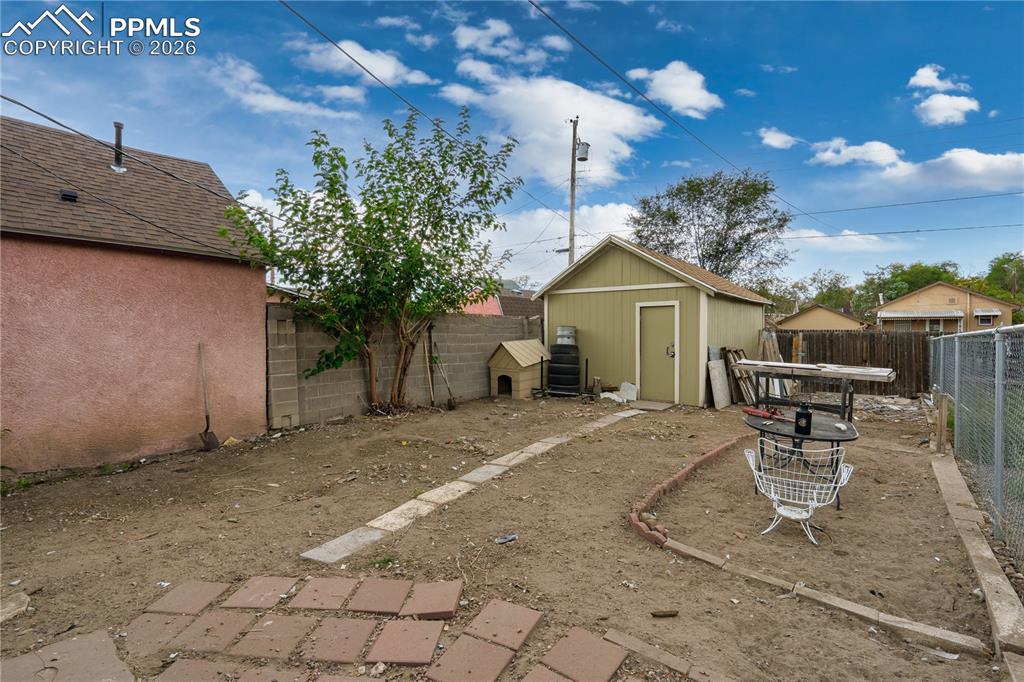 Image 8 of 18: Fenced backyard featuring a shed