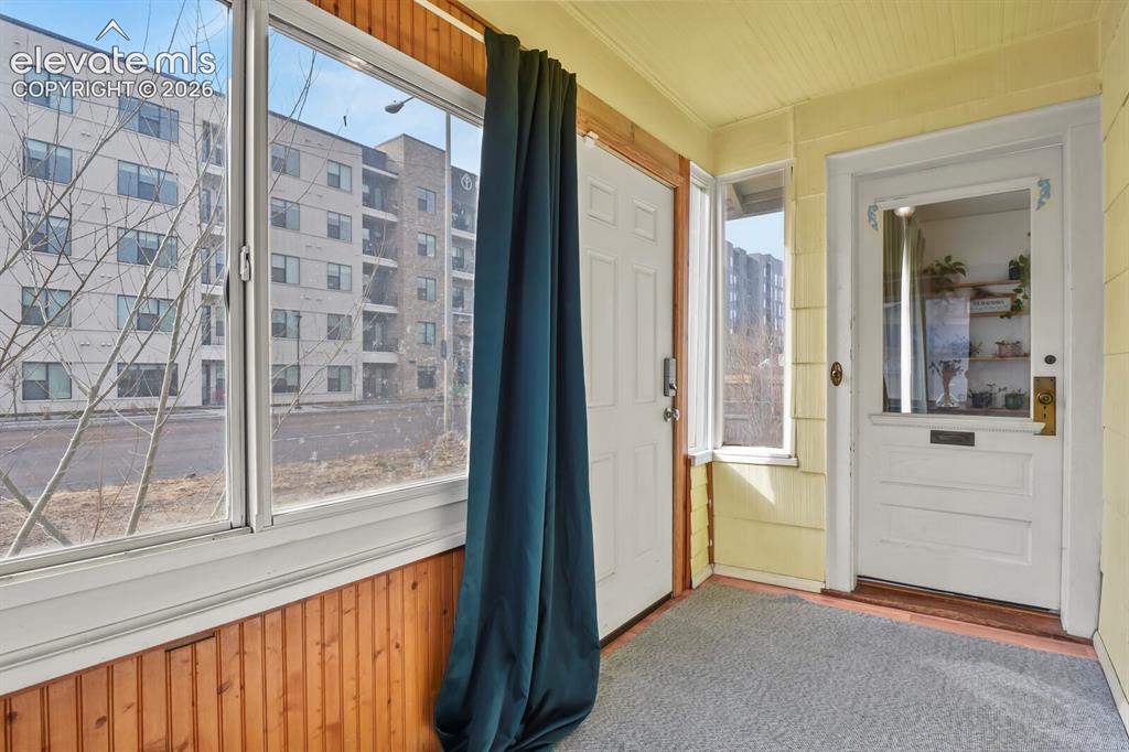 Image 26 of 36: Charming entryway and sunroom