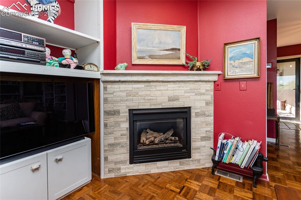Image 10 of 46: Living room with a textured wall and a fireplace