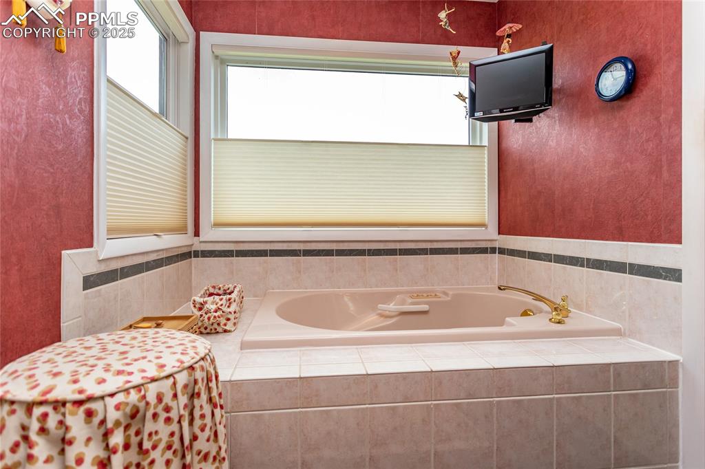 Image 19 of 46: Bathroom with a bath