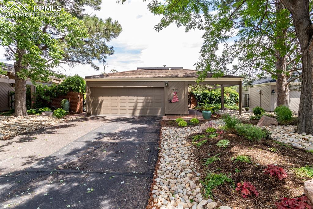 Image 43 of 46: Ranch-style house with driveway, a garage, a shingled roof, and a gate