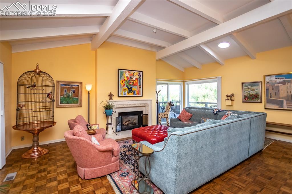 Image 6 of 46: Living area featuring a high end fireplace and baseboards