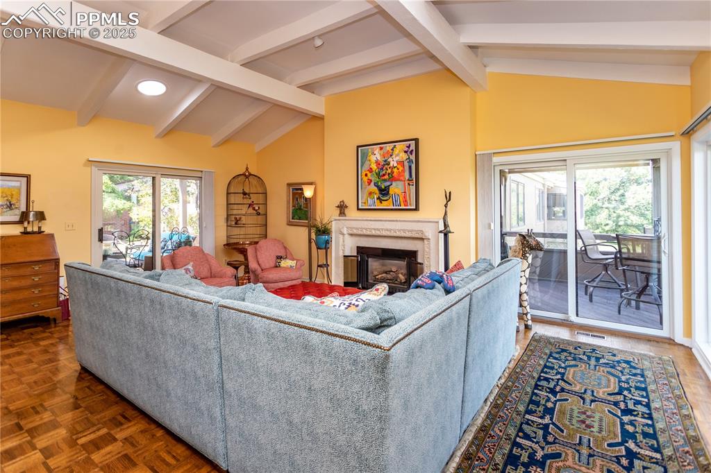 Image 7 of 46: Living room featuring a high end fireplace and parquet floors