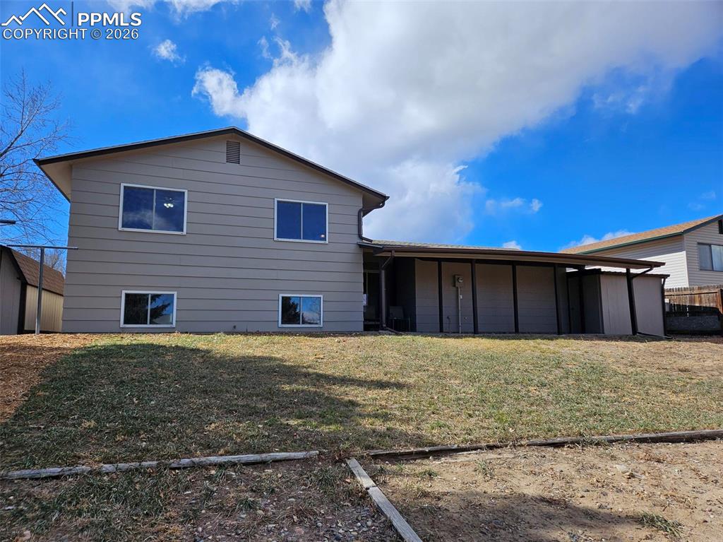 Image 30 of 35: Rear view of home with patio
