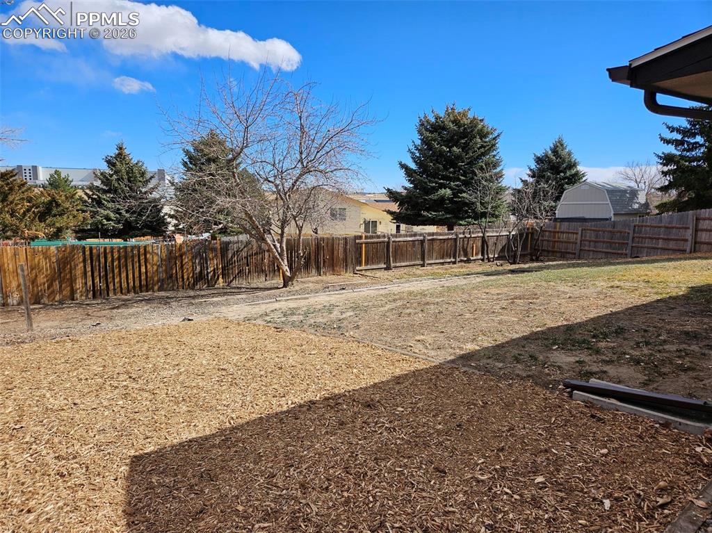 Image 32 of 35: View of fenced backyard
