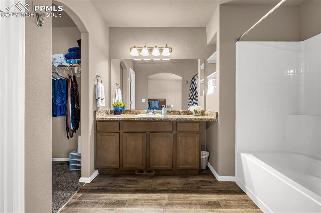 Image 11 of 19: Ensuite bath with large vanity, separate toilet and massive closet