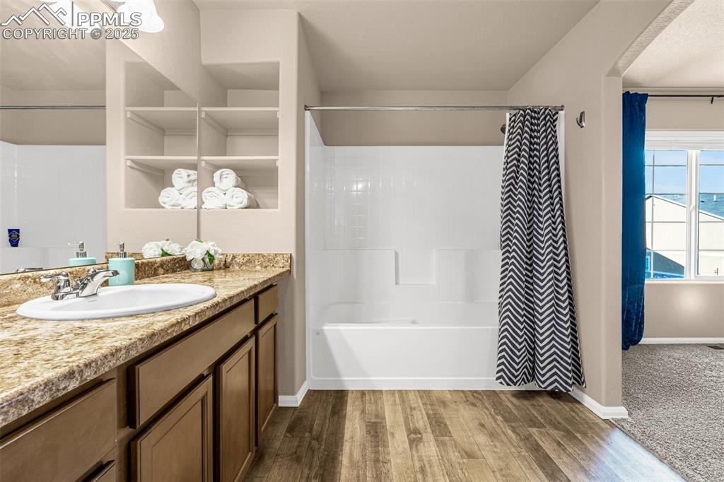 Image 12 of 19: Tub/shower combo and plenty of of built-in storage.