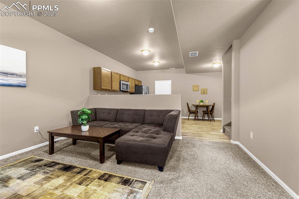 Image 3 of 19: Immaculate living room/ kitchen area on main floor