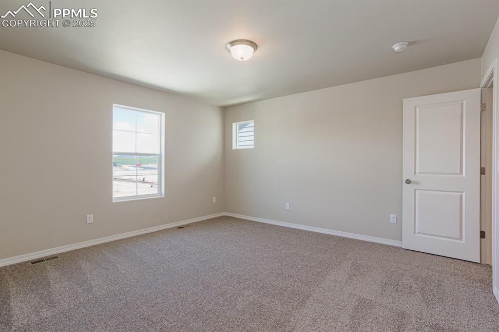 Image 24 of 26: Unfurnished room featuring carpet flooring, a smoke detector, and baseboard