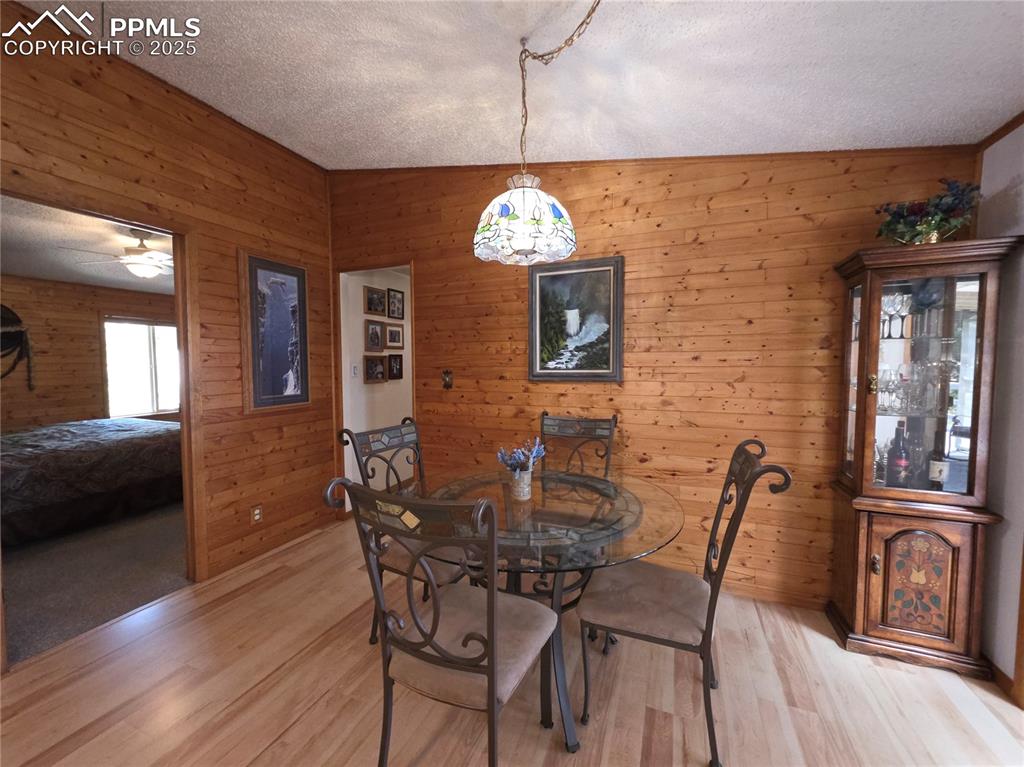 Image 14 of 50: T&G make the DR space across from the kitchen very homey and warm