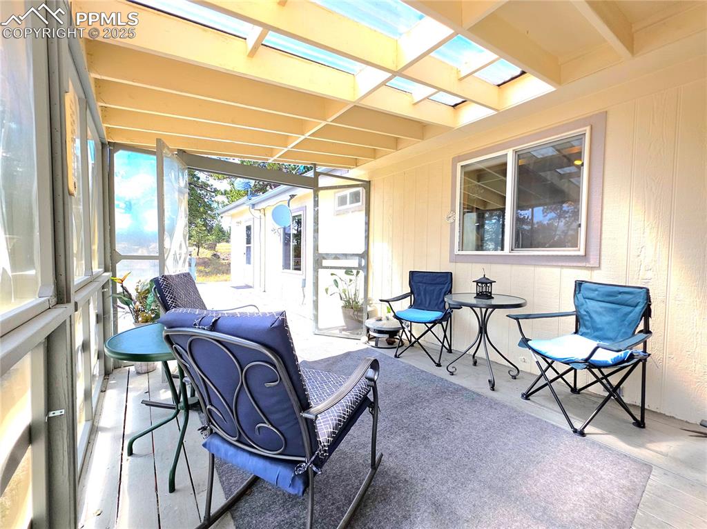 Image 18 of 50: enclosed with a skylight roof and sturdy plexi window walls, enjoy the spac