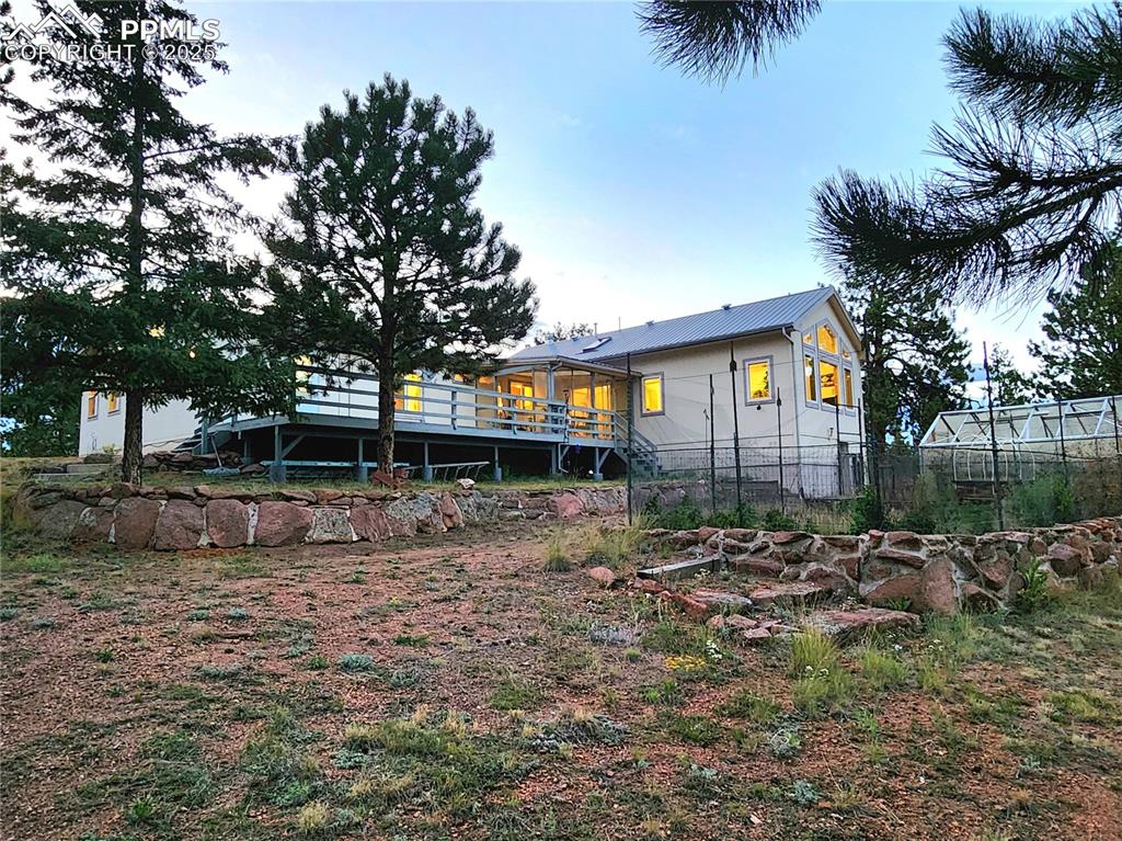 Image 32 of 50: Airy and spacious back deck walks out to the level back yard area which cou